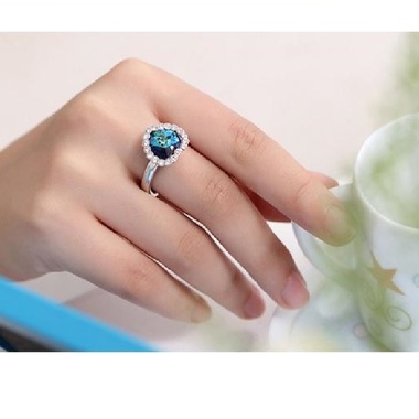 Gifts 4 All, Very pretty heart ring. The heart is of simulated crystal in blue color, surrounded by clear crystals. Silver tone ring. Adjustable ring. 
