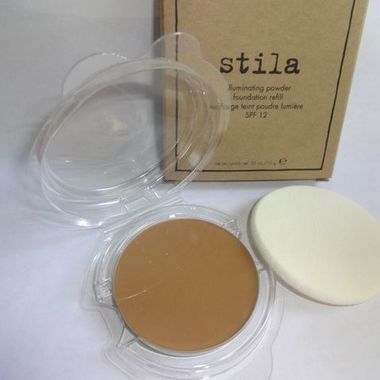 Gifts 4 All, Stila illuminating powder foundation Refill
Shade: 80 Watt
Size: 10g / 0.35oz
Illuminate your face to bring out its beauty with the Stila Illuminating Powder Foundation. Formulated with tiny crystals of Mica, this makeup powder will make your skin radiate with freshness. The Stila Illuminating Powder diminishes skin imperfections and brings forth an ageless glowing skin. This makeup powder is fortified with SPF 12 so it is a good choice for daytime wear as well. Applying this Stila foundation is easy and it is also perfect to take along for easy touch ups on the go. You can apply this Stila foundation dry when you need a light coverage, or with a damp sponge for a complete coverage. You can use a makeup brush for a sheer finish with the Stila Illuminating Powder that is perfect for all skin types.

BRAND NEW ~ NEVER USED ~ IN ORIGINAL BOX
Comes in a sealed clamshell with sponge applicator. Can be used with or without a compact